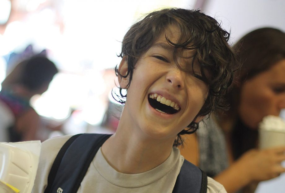 Boy laughing in dining hall
