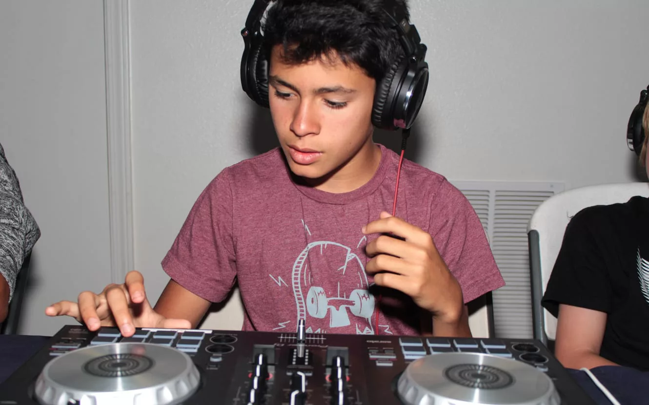 Boy learning to DJ