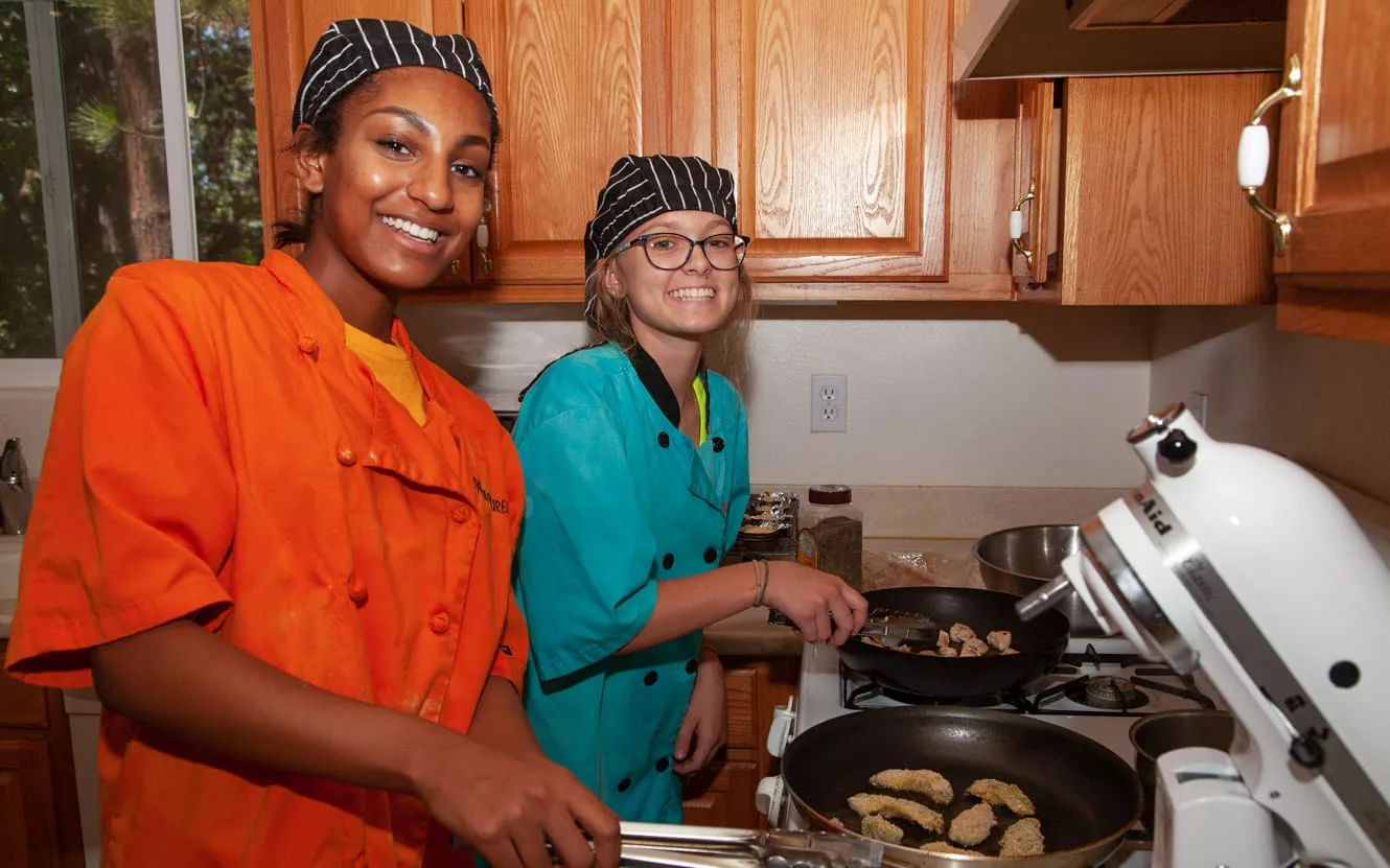 Two females during culinary activity