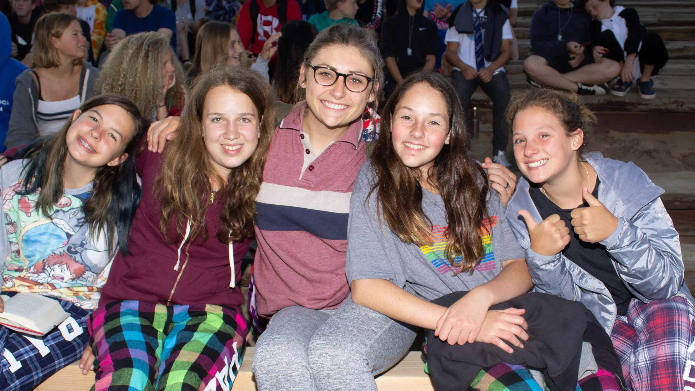 Female campers and staff posing for photo at camp event