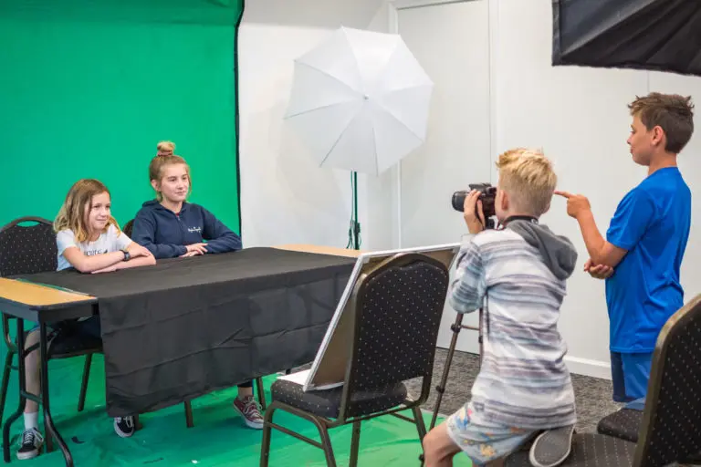 kids doing a newscast on a green screen