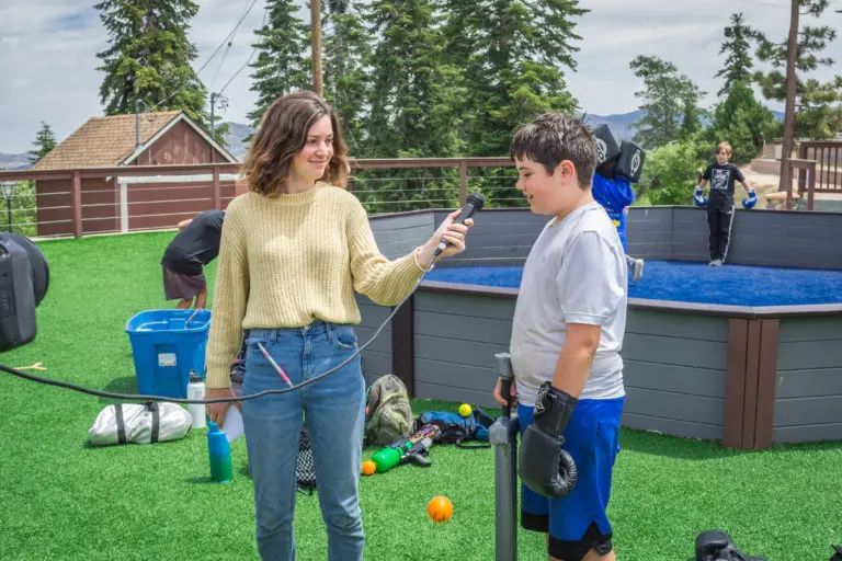 a girl interviewing a boy for broadcast camp