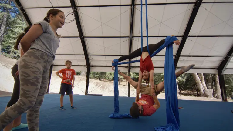 a girl holding her instructor while performing