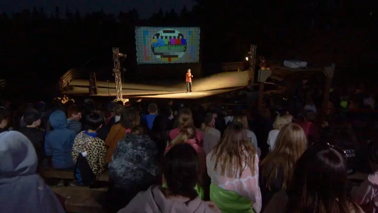 a boy performing comedy on stage