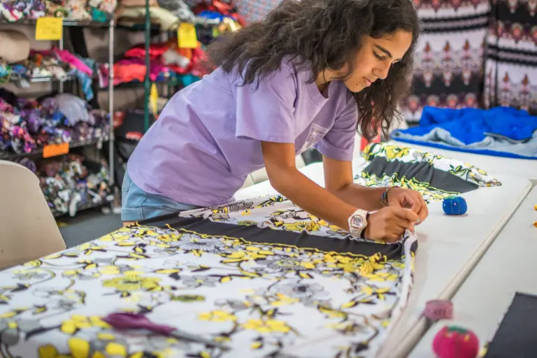 a girl measuring fabric