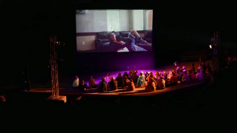 kids watching a film on the large screen