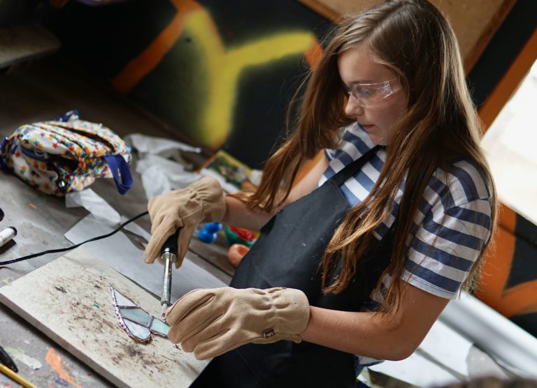 a girl making a stained glass heart