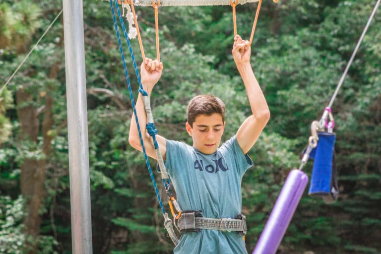 a boy getting ready for the flying trapeze