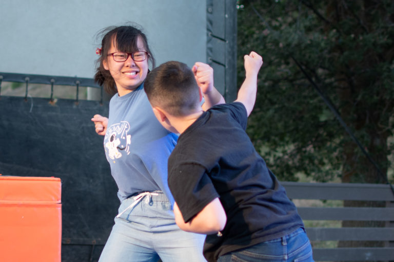 a boy and a girl fake fighting