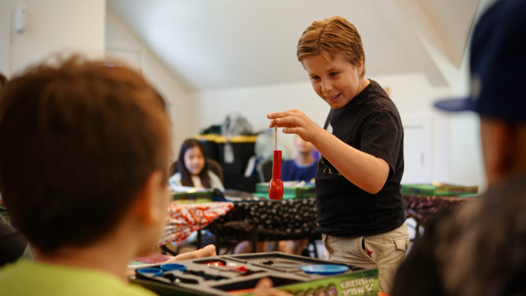 a boy showing off a magic trick