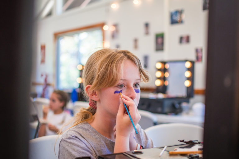 a girl painting her face