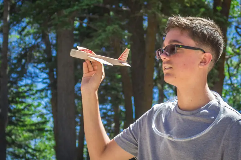 a boy holding a toy airplane