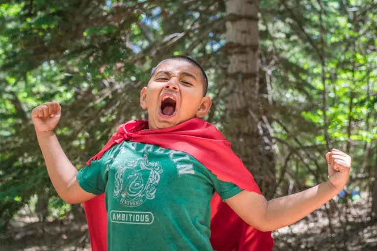 boy in red cape at LARP camp