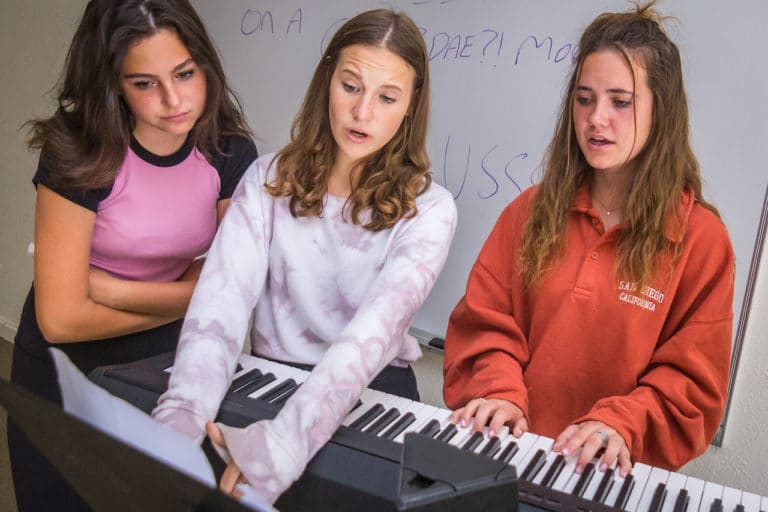 girls playing piano