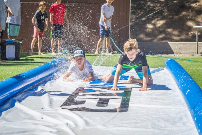 kids playing on slip and slide