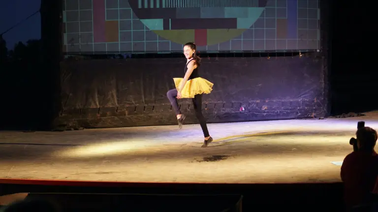 girl performing in yellow tutu
