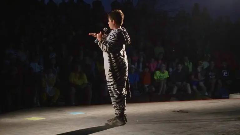 a boy in a zebra costume doing stand up comedy