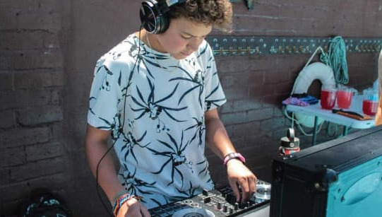 Camper mixing music on DJ decks