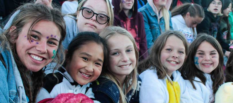 Mini Camp counselor and campers smiling together